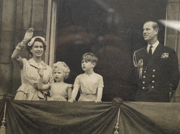 A framed photograph of Queen Elizabeth II, Prince Philip, King Charles and Princess Anne, signed by both the Queen and Prince Philip in ink, with each signature under their relevant image and dated 1954, contained within